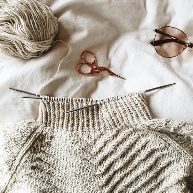 Person wearing a cozy merino wool sweater