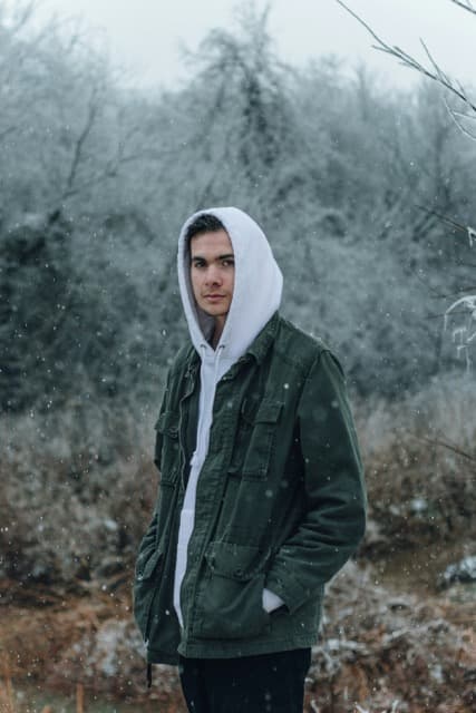 Person wearing a sleek recycled polyester raincoat